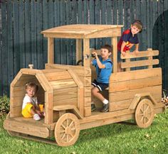 two children are playing in a wooden truck