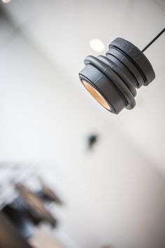 a black light hanging from a ceiling in a room with white walls and flooring