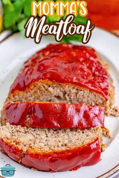 a meatloaf with ketchup is on a white plate