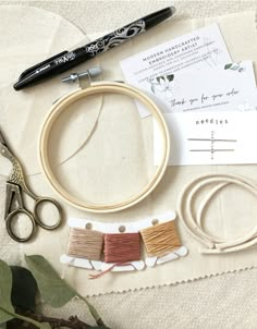 sewing supplies laid out on a table with scissors, thread and other crafting items