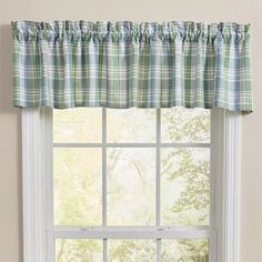 a window with a green and blue checkered valance