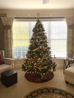 a living room with a christmas tree in the corner