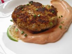 a piece of crab cake on a plate with sauce