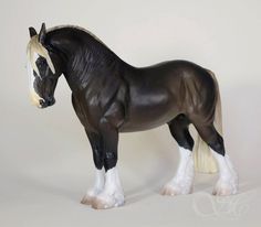 a black and white toy horse standing on its hind legs