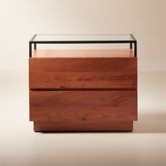 a wooden dresser with glass top and drawers on the bottom, against a white background