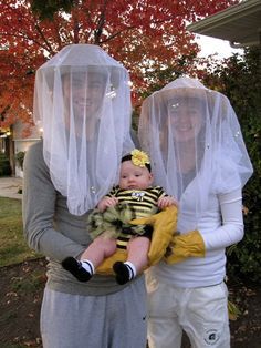 two women and a baby wearing bee costumes