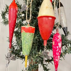 an assortment of christmas ornaments hanging from a tree