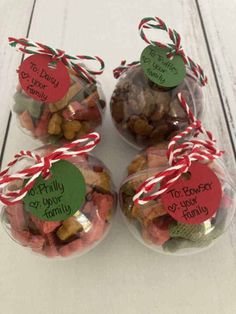 four small bags filled with candy canes and candies