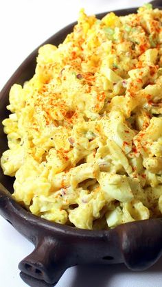 a bowl filled with macaroni and cheese on top of a table