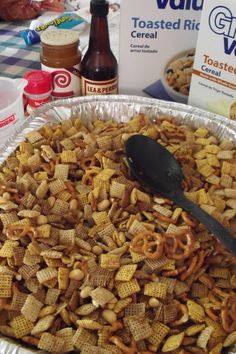 a large metal pan filled with cheetos sitting on top of a checkered table cloth