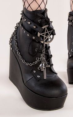 The Poison wedge series feature wickedly stylish designs. Cages and cute charms and chains, oh my! Vegan Black PU leather 5 inch platform Ankle bootie Pentagram charm Studded straps Side zip Studded heel Chains with cross charms Lace up U.S women's sizing-refer to size chart for more info Platform Goth Boots, Gothic Platform Ankle Boots, Boots With Chains, Alternative Boots, Goth Heels, Goth Platform Boots, Platforms Shoes, Demonia Boots, Alternative Shoes