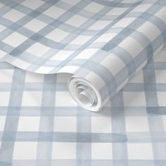 a blue and white checkered wallpaper with a rolled up roll