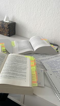 an open book sitting on top of a white desk next to papers and pentagrams