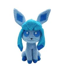 a small stuffed animal with blue eyes and ears