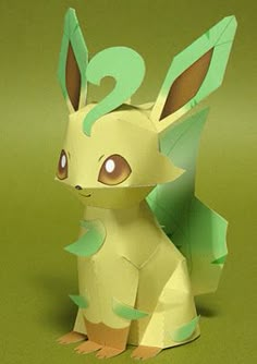 a paper sculpture of a pikachu sitting on top of a green tablecloth