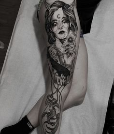 a woman's leg with tattoos on it