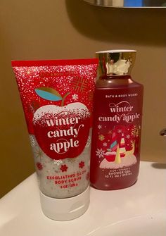 a bottle of body lotion next to a tube of hand soap on a sink