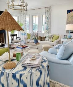 a living room filled with furniture and a large umbrella over the couches in front of a fire place