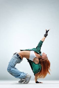 a woman is doing a handstand on the floor