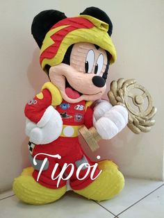 a mickey mouse statue with the word tipo on it's chest and arms