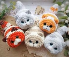 small crocheted stuffed animals sitting next to each other on top of a table