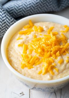 a bowl of oatmeal with cheese on top