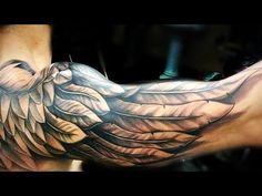 a man's arm with an eagle tattoo on it