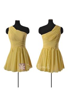 two mannequins with yellow dresses on display in front of a white background