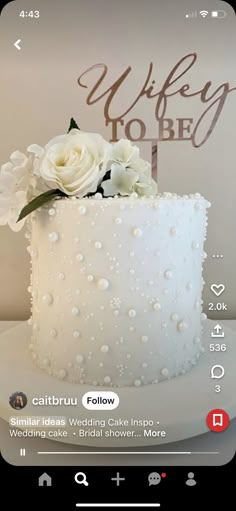 a wedding cake with white flowers on top and the words'wife to be'above it