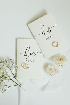 two wedding rings on top of a card next to flowers and a flower bouquet, with the words her vows written in cursive