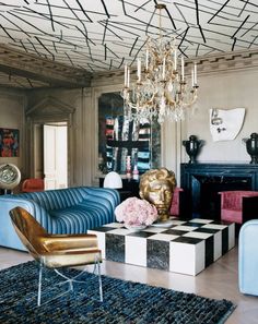 a living room filled with furniture and a chandelier