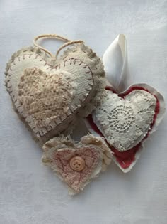 two heart shaped ornaments are sitting on a table