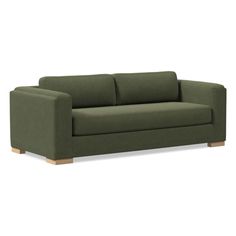 a green couch sitting on top of a white floor