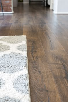 a wooden floor with a white rug on it