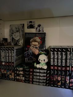 there are many anime books on the shelf