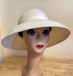 This classic Ivory wool felt lampshade hat has a 4 1/2 inch brim all around. The hat will fit up to a 22- 22 1/2  inch head size. The ivory grosgrain ribbon is removable if you would like to put another band on. NOTE: Please check the head size before purchase, I am happy to answer any questions you may have. There will be a 20% restocking fee for all returned hats. Classic White Felt Hat With Short Brim, White Brimmed Felt Hat For Kentucky Derby, White Brimmed Felt Hat For Formal Occasions, Cream Fitted Brimmed Felt Hat, Fitted Brimmed Cream Felt Hat, Vintage White Fedora With Short Brim, Fitted Cream Felt Hat With Brim, White Wide Brim Felt Hat For Formal Occasions, Classic Adjustable Cream Top Hat