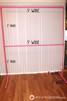 a pink metal rack with five wide and 5 wide width measurements on the wall next to a hardwood floor