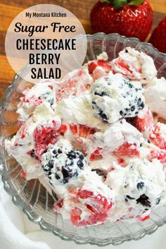 a bowl full of cheesecake salad with strawberries and blueberries on the side