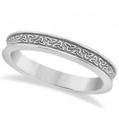 a white gold wedding ring with hearts on the side and celtic design in the middle