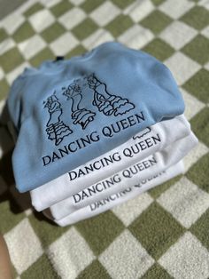 two blue hats sitting on top of a green and white checkered table cloth