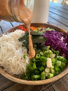 the salad is prepared and ready to be eaten with dressing on it, including shredded vegetables