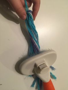 someone is pulling the yarn off of a hair dryer