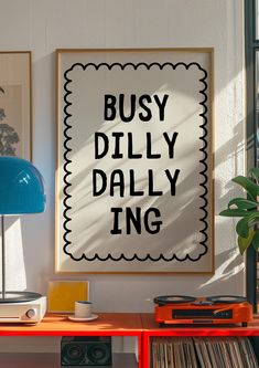 a poster that says busy dillly ing on the wall next to a record player