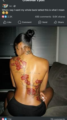 the back of a woman's body with flowers tattooed on her upper and lower back