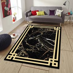 a living room with a couch, chair and rug in black and gold marble pattern