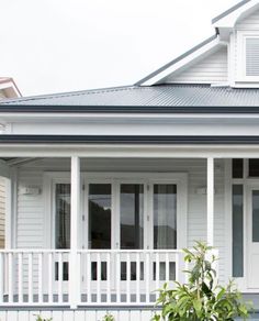 a white house with blue trim and windows