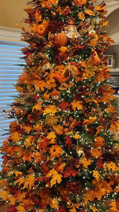 a decorated christmas tree with orange and yellow leaves