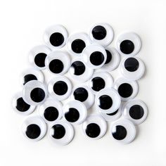 a bunch of black and white eyeballs on a white surface