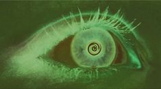 an eye is shown in the middle of this image, with green light coming from its iris