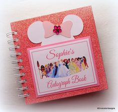 a pink notebook with minnie mouse ears on top and other disney characters around the page